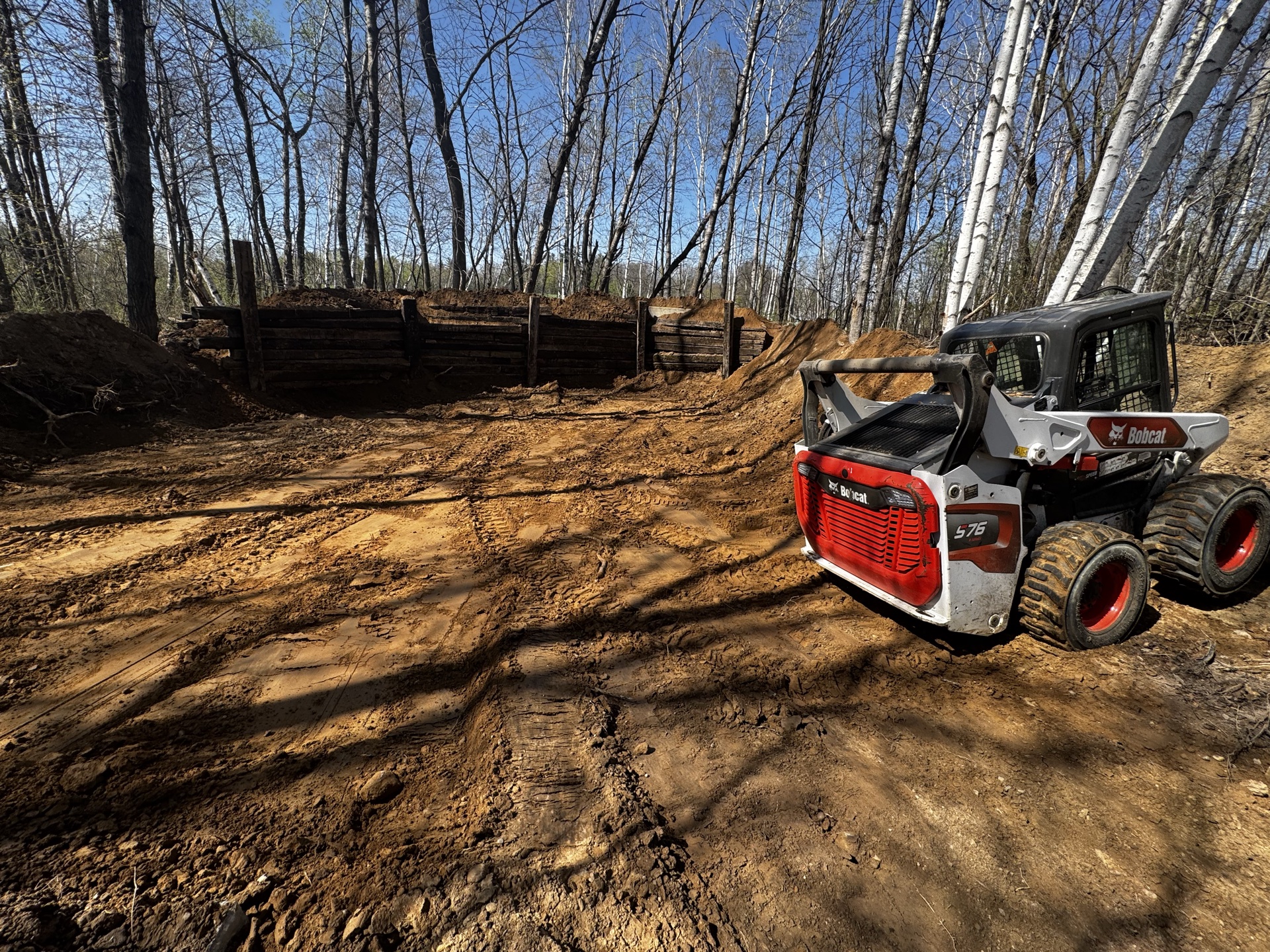 Land clearing with retaining wall