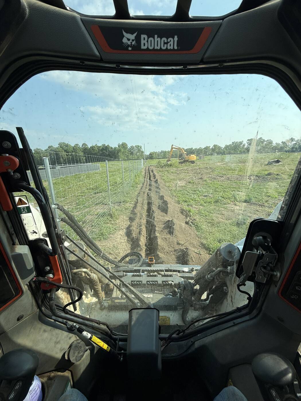 Cab view of a 1,000-foot trench run along a fence line in Long Prairie, MN